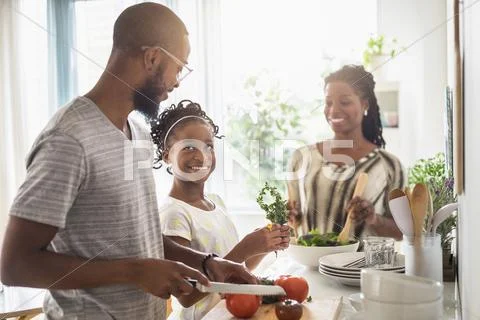 Black Family Cooking In Kitchen