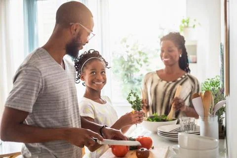 Black family cooking in kitchen Stock Photos