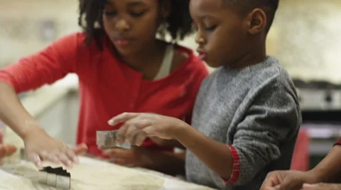 Black family making Christmas cookies with pastry cutter Stock Footage