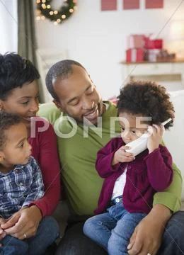 Black Family Watching Girl Talking On Telephone