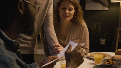Black Father Looking at Sons Exam Papers with Excellent Grades at Table at Home Stock Footage 335322478