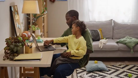 Black Father Working Remotely on Laptop with Little Son at Home Stock Footage 345491855