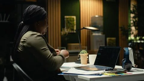 Black female administrator analyzes data on stock and forex trading Stock Photos