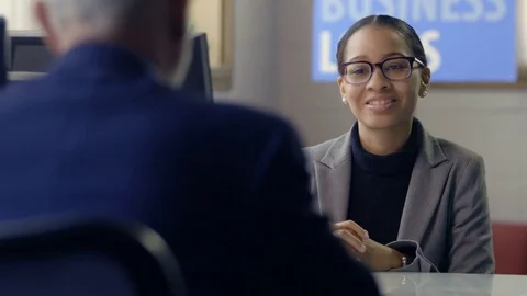 Black female banker meeting with client for a business loan Stock Footage