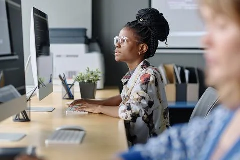 Black Female Coder Typing on Office Computer 스톡 사진