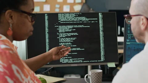 Black Female Developer Teaching Coding to Male Employee in Office Stock Footage 306846626