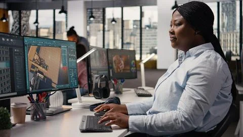Black female graphic designer using remodeling software for modern floor plan Stock Photos