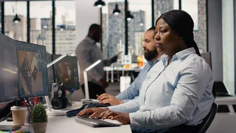 Black female graphic designer using remodeling software for modern floor plan Stock Photos