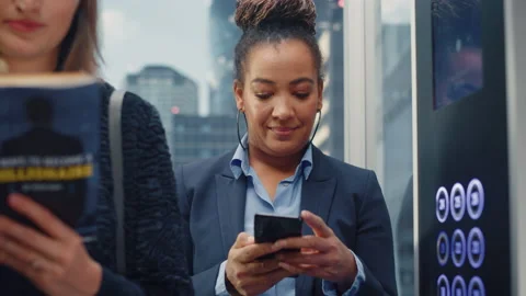Black Female Riding Elevator to Office Using Smartphone 스톡 동영상 167837383
