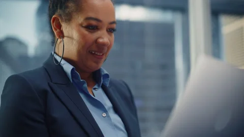 Black Female Riding Elevator to Office Using Laptop Stock Footage 167839975