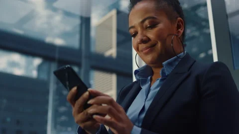 Black Female Riding Elevator to Office Using Smartphone Stock Footage 167840929