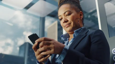 Black Female Riding Elevator to Office Using Smartphone Stock Footage 167840953