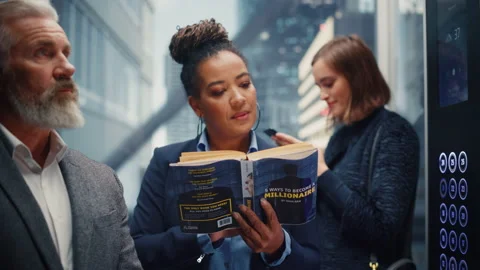 Black Female Riding Elevator Reading Book 스톡 동영상 167836387