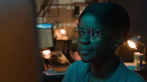 Black Female Software Engineer Coding with Screen Reflection in Glasses 動画素材 336718229