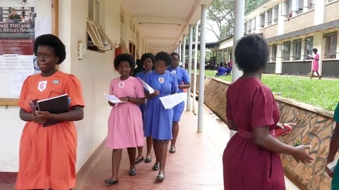 Black female students are walking, talking and discussing in colorful uniforms Stock Footage 85132041