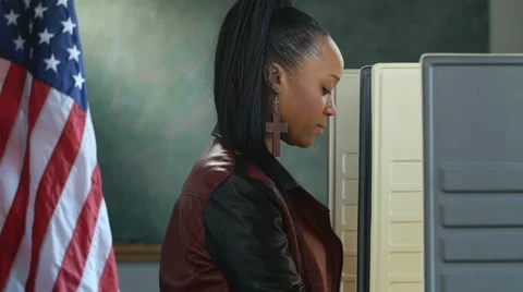 Black female voting in a voting booth, profile shot Stock Footage 61409920