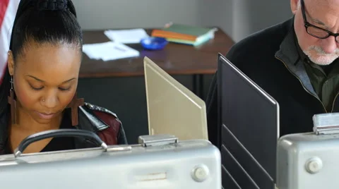 Black female voting in a voting booth, overhead view Stockbeeldmateriaal 61410180