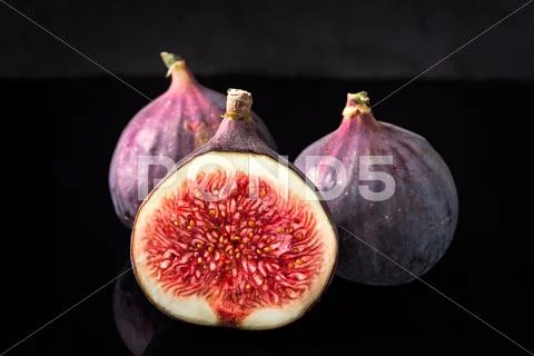 Black Figs Isolated On Black Board And Dark Reflections