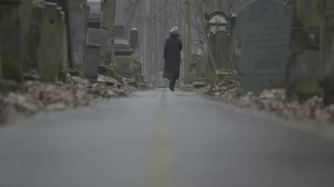 Black figure in the cemetery. 4K Stock Footage 148757356