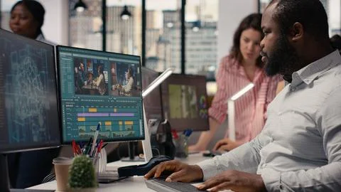 Black filmmaker using AI-driven editing software for cutting montage clips Stock Photos