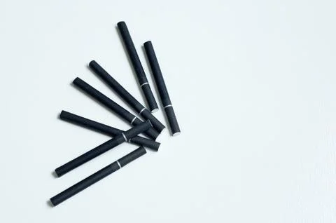 Black filter cigarettes on a white background. View from above. Stock Photos