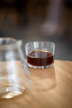 Black filter coffee on the table in cafe glass cup hario pour over cup Foto stock