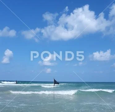 Black flag on the sea - a signal of danger for bathers. Stock Photos