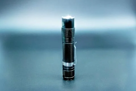 Black flashlight with a grey background Stock Photos