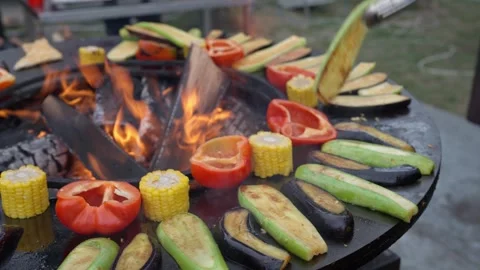 Black flat grill, round shape, with a hole with a fire in the center. 動画素材 337038894