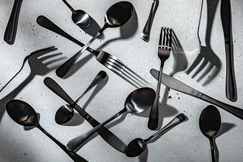 Black flatware on neutral gray concrete background Stock Photos