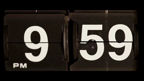 Black flip clock changing from nine fifty nine pm Stock Footage 329667673