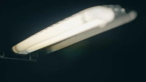 Black fluorescent table lamp shines brightly in the dark Stock Footage 297760783