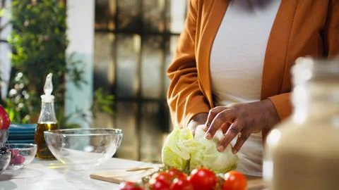 Black food content creator preparing iceberg salad leaves on cooking video 写真素材