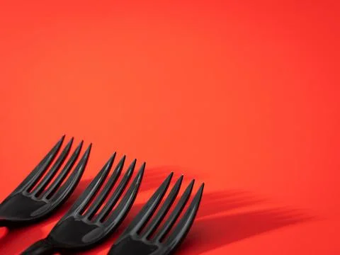 Black fork on a red background Stock Photos