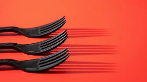 Black fork on a red background Stock Photos