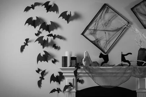 Black frames with cobweb on white wall, paper bats and different Halloween .. Stock Photos