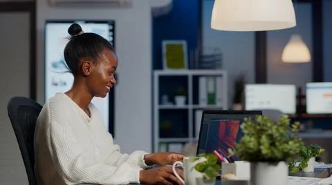 Black freelancer game developer typing on keyboard developing videogame Stock Photos