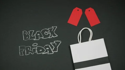 Black friday appears from the white bag on black background. Video stock 115600399