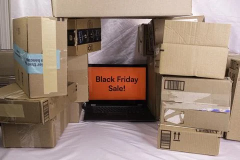 Black Friday boxes around a PC with Black Friday Sale displayed. Stock Photos