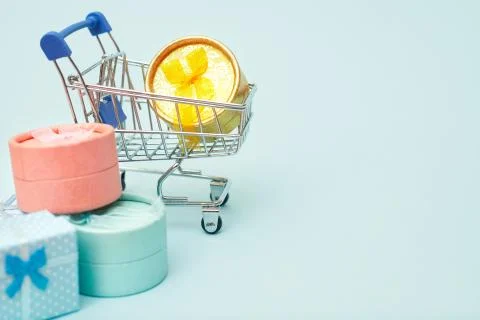 Black friday concept, gift boxes with shopping trolley on blue pastel background Stock Photos