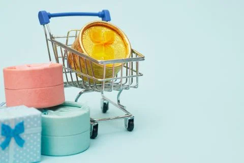 Black friday concept, gift boxes with shopping trolley on blue pastel background Stock Photos