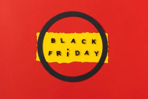 Black friday concept. Top view of yellow torn paper sheet and black friday text Stock Photos