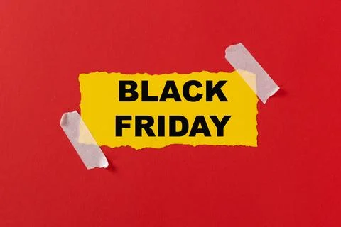 Black friday concept. Top view of yellow torn paper sheet and black friday text Stock Photos