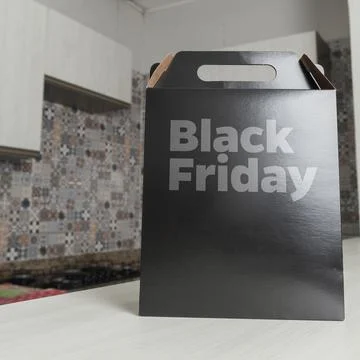 Black Friday gift box on the table with black packaging with writing in dark  Foto stock
