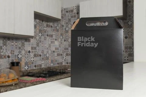 Black Friday gift box on the table with black packaging with writing in dark  Fotos de archivo