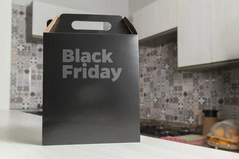 Black Friday gift box on the table with black packaging with writing in dark  Stock-Fotos