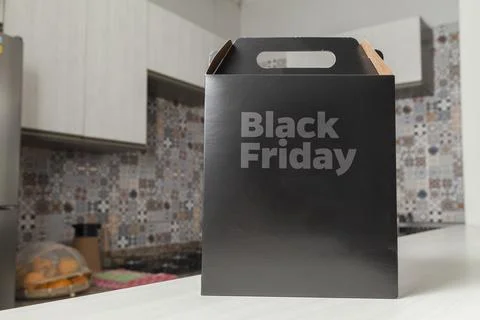 Black Friday gift box on the table with black packaging with writing in dark  Фото