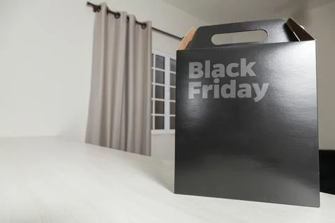 Black Friday gift box on the table with black packaging with writing in dark  Fotos Stock