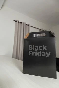 Black Friday gift box on the table with black packaging with writing in dark  Fotos de archivo