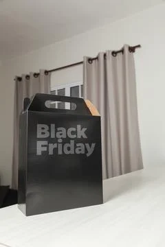 Black Friday gift box on the table with black packaging with writing in dark  Photos